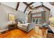 Cozy bedroom featuring vaulted ceiling, wood beams, warm hardwood floors, and a comfortable sitting area at 1307 Wyndmere Hills Ln, Matthews, NC 28105