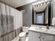 Well-lit bathroom featuring a vanity, modern mirror, and patterned shower curtain at 1323 Queens Rd # 424, Charlotte, NC 28207