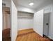 Walk-in closet featuring hardwood floors and efficient shelving for storage at 1323 Queens Rd # 424, Charlotte, NC 28207