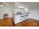 Open kitchen with white cabinets, breakfast bar with stools and hardwood flooring at 1323 Queens Rd # 424, Charlotte, NC 28207