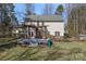 Backyard featuring a large deck, a pergola, and mature trees for shade and privacy at 15314 Logan Grove Rd, Charlotte, NC 28227