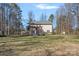 Expansive backyard with a pergola, mature trees, and a lush lawn at 15314 Logan Grove Rd, Charlotte, NC 28227