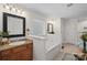 Bathroom featuring a bathtub with tile surround, vanity with granite countertop, and neutral walls at 15314 Logan Grove Rd, Charlotte, NC 28227