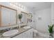 Bright bathroom featuring double sinks with granite countertop and a tiled shower with glass door at 15314 Logan Grove Rd, Charlotte, NC 28227