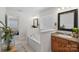 Bathroom showcasing a soaking tub with tile surround, granite vanity, and a view to the bedroom at 15314 Logan Grove Rd, Charlotte, NC 28227