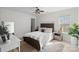 Bedroom with a wooden bed frame, ceiling fan, neutral walls, and a sunny window at 15314 Logan Grove Rd, Charlotte, NC 28227