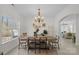 Dining room featuring a wooden table, stylish chairs, and a modern chandelier at 15314 Logan Grove Rd, Charlotte, NC 28227