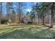 Charming two-story home with a well-manicured lawn and mature trees at 15314 Logan Grove Rd, Charlotte, NC 28227