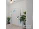 Bright foyer with a white front door with sidelights and tile flooring at 15314 Logan Grove Rd, Charlotte, NC 28227