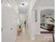 Hallway with arched entrances, white wainscotting, and tile floors at 15314 Logan Grove Rd, Charlotte, NC 28227