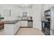 Bright, open kitchen featuring stainless steel appliances, white cabinets and an open layout to the dining area at 15314 Logan Grove Rd, Charlotte, NC 28227
