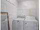 Clean laundry room equipped with modern appliances and storage shelves at 15314 Logan Grove Rd, Charlotte, NC 28227