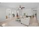 Inviting living room with neutral tones, archways, ceiling fan, and comfortable furniture at 15314 Logan Grove Rd, Charlotte, NC 28227