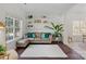 Cozy living room with a large window, floating shelves, and a comfortable sofa at 15314 Logan Grove Rd, Charlotte, NC 28227