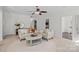 Bright living room with cozy seating, neutral decor, and a welcoming atmosphere with tile floors throughout at 15314 Logan Grove Rd, Charlotte, NC 28227
