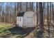 Outdoor shed for additional storage on a wooded lot at 15314 Logan Grove Rd, Charlotte, NC 28227