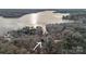Aerial view showcasing the property's proximity to a large lake surrounded by lush trees at 1665 Sherwood Ct, Sherrills Ford, NC 28673