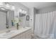 Bathroom features a double vanity, stylish light fixture, and a bathtub with shower at 1665 Sherwood Ct, Sherrills Ford, NC 28673