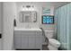 Bathroom features a modern vanity, stylish light fixture, decorative stained glass, and toilet at 1665 Sherwood Ct, Sherrills Ford, NC 28673