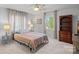 Bedroom features a ceiling fan, large window, dresser, and bedside tables with lamps at 1665 Sherwood Ct, Sherrills Ford, NC 28673