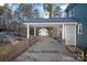 Carport with white columns and stone accents next to matching shed at 1665 Sherwood Ct, Sherrills Ford, NC 28673
