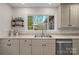 Bright kitchen featuring a stainless steel sink, modern faucet and window view to the backyard at 1665 Sherwood Ct, Sherrills Ford, NC 28673