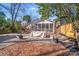 A backyard with a screened porch, a wooden deck, a graveled area, and mulch ground cover at 1720 Fulton Ave, Charlotte, NC 28205