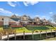 A view of the townhomes from the water, showcasing the community's backyard and deck areas at 18409 Harborside Dr, Cornelius, NC 28031