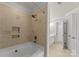Neutral colored bathroom with shower and tub combination with decorative tile and storage niche at 18409 Harborside Dr, Cornelius, NC 28031