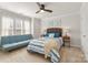 A beautifully staged bedroom with soothing colors, a futon, natural light and ceiling fan at 18409 Harborside Dr, Cornelius, NC 28031
