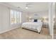 A spacious bedroom with a large window offering natural light, neutral walls, carpet, and ceiling fan at 18409 Harborside Dr, Cornelius, NC 28031