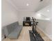 A bonus room with neutral walls, carpet, and a futon, with an exercise bike and TV viewing area at 18409 Harborside Dr, Cornelius, NC 28031
