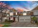 Beautiful brick townhome showcasing an attached two car garage and covered porch, offering curb appeal at 18409 Harborside Dr, Cornelius, NC 28031
