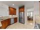 This stylish kitchen features stainless steel appliances and rich wood cabinetry, complemented by granite countertops at 18409 Harborside Dr, Cornelius, NC 28031