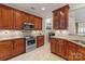 The gourmet kitchen features stainless steel appliances, granite countertops, and beautiful wood cabinetry at 18409 Harborside Dr, Cornelius, NC 28031