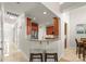 Open kitchen with a granite countertop bar, leading into a bright area, and views of the front entrance at 18409 Harborside Dr, Cornelius, NC 28031