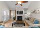 Comfortable living room with a fireplace, built-in shelving and outside access at 18409 Harborside Dr, Cornelius, NC 28031