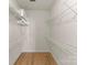 Empty walk-in closet with built in shelving and wood flooring at 18409 Harborside Dr, Cornelius, NC 28031
