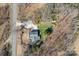 An aerial view of a house with a well-kept yard and long driveway in a rural, wooded neighborhood at 19320 Davidson Concord Rd, Davidson, NC 28036