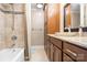 Bathroom with a shower and tub combination and dark wood cabinets at 19320 Davidson Concord Rd, Davidson, NC 28036