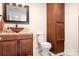 Bathroom featuring a vessel sink, granite countertops, and wooden cabinets at 19320 Davidson Concord Rd, Davidson, NC 28036