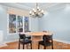 Bright dining area with modern chandelier and view of treelined yard at 19320 Davidson Concord Rd, Davidson, NC 28036