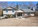 Charming home featuring a manicured lawn, inviting front porch, and beautiful water fountain centerpiece at 19320 Davidson Concord Rd, Davidson, NC 28036