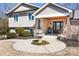 Inviting front porch with a rocking chair, tiered fountain, and beautifully trimmed landscaping at 19320 Davidson Concord Rd, Davidson, NC 28036