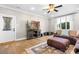 Living room with wood flooring, a ceiling fan, and a large window at 19320 Davidson Concord Rd, Davidson, NC 28036