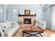Living room with stacked stone fireplace, hardwood floors, and ample natural light at 19320 Davidson Concord Rd, Davidson, NC 28036
