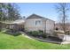 A beautifully landscaped backyard showcases a screened porch and a paved driveway at 19320 Davidson Concord Rd, Davidson, NC 28036