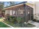 Enclosed screened porch with a ceiling fan and outdoor furniture, perfect for relaxing at 19320 Davidson Concord Rd, Davidson, NC 28036
