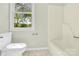 Neutral bathroom with a bathtub and a window view and tiled floor at 2041 Jefferson Ave, Gastonia, NC 28056