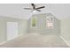 Bedroom featuring neutral carpet, two windows, and a white door at 2041 Jefferson Ave, Gastonia, NC 28056